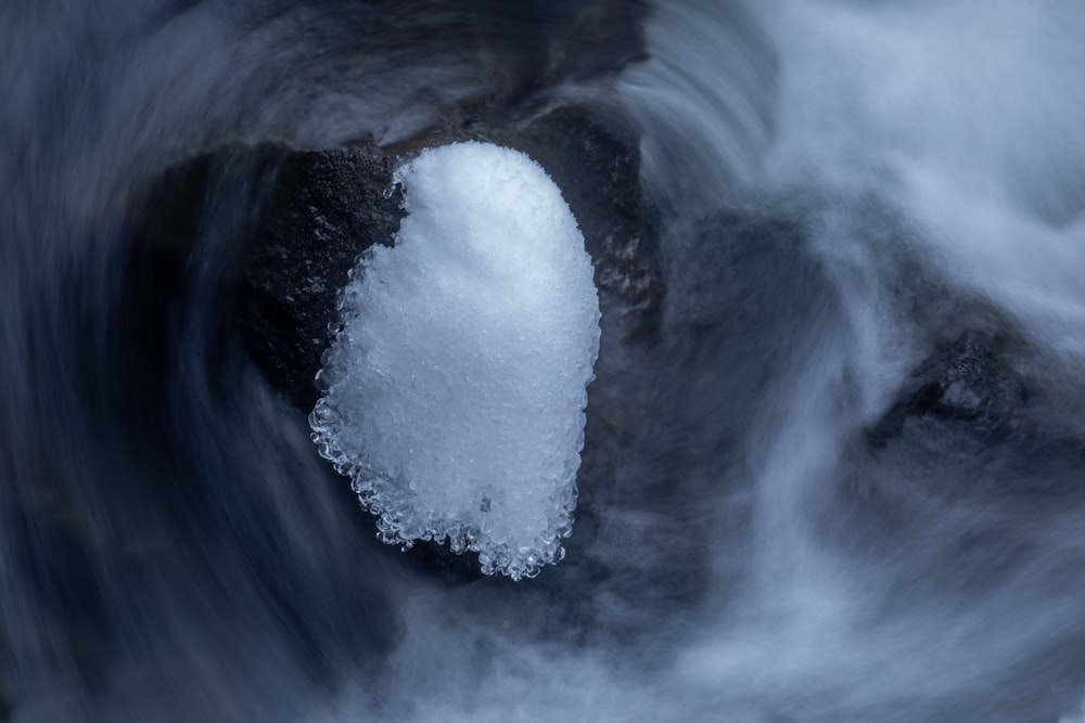 a close up of a rock with ice on it