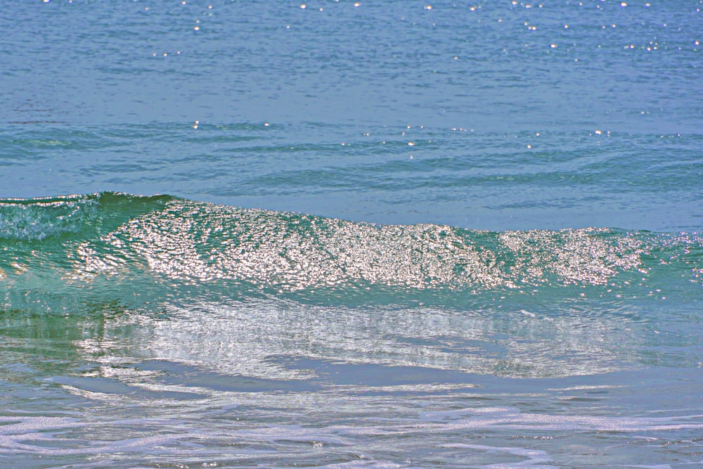 a person riding a surfboard on a wave in the ocean