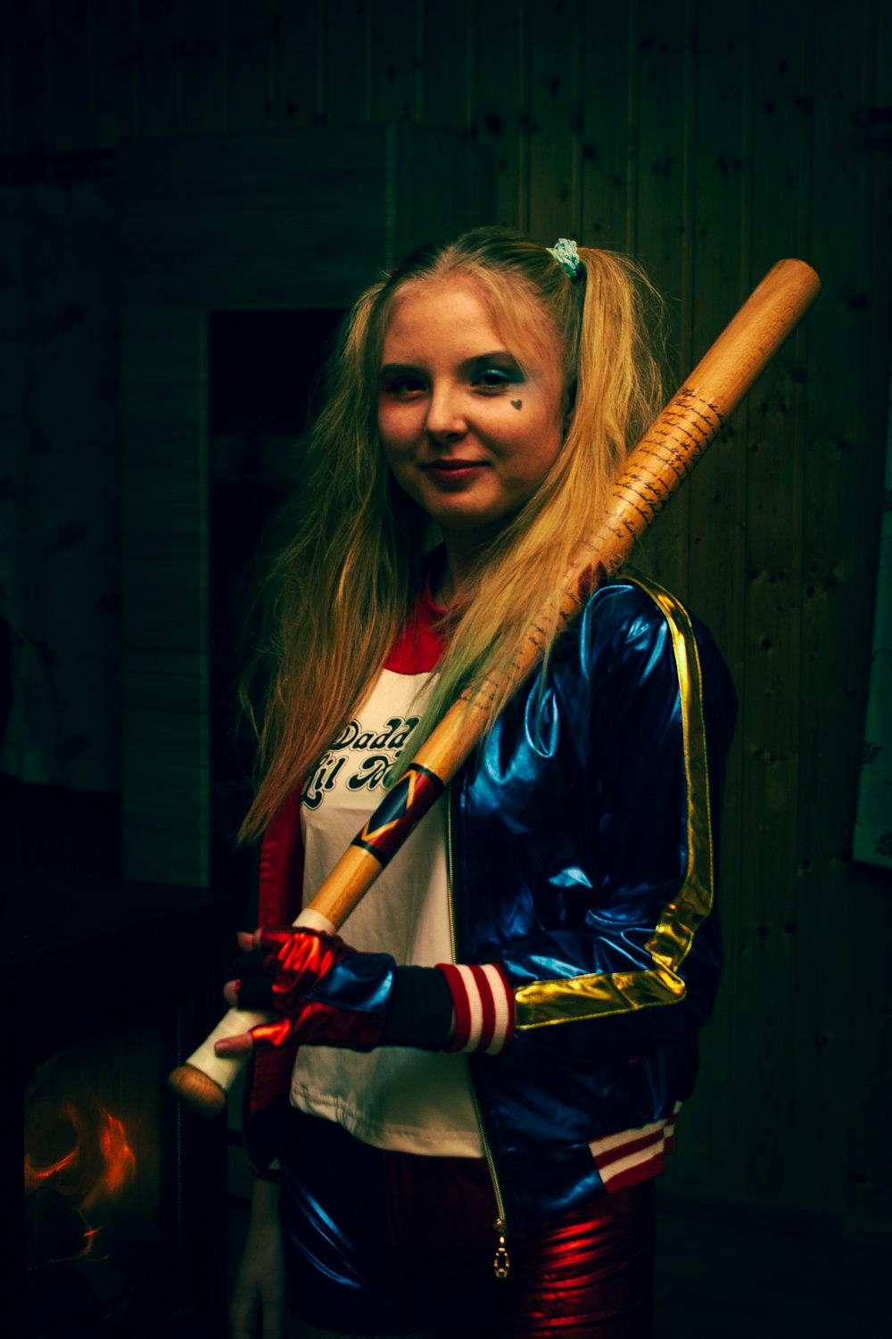 a woman holding a baseball bat in a room