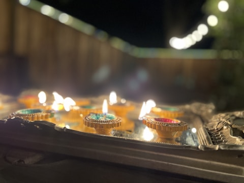 Candles lit during a festive celebration outdoors.