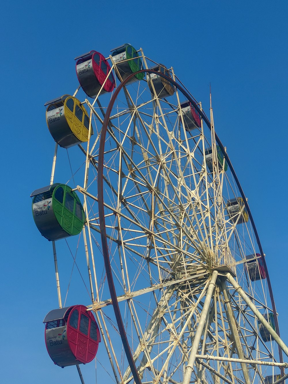 a colorful ferris wheel against a blue sky