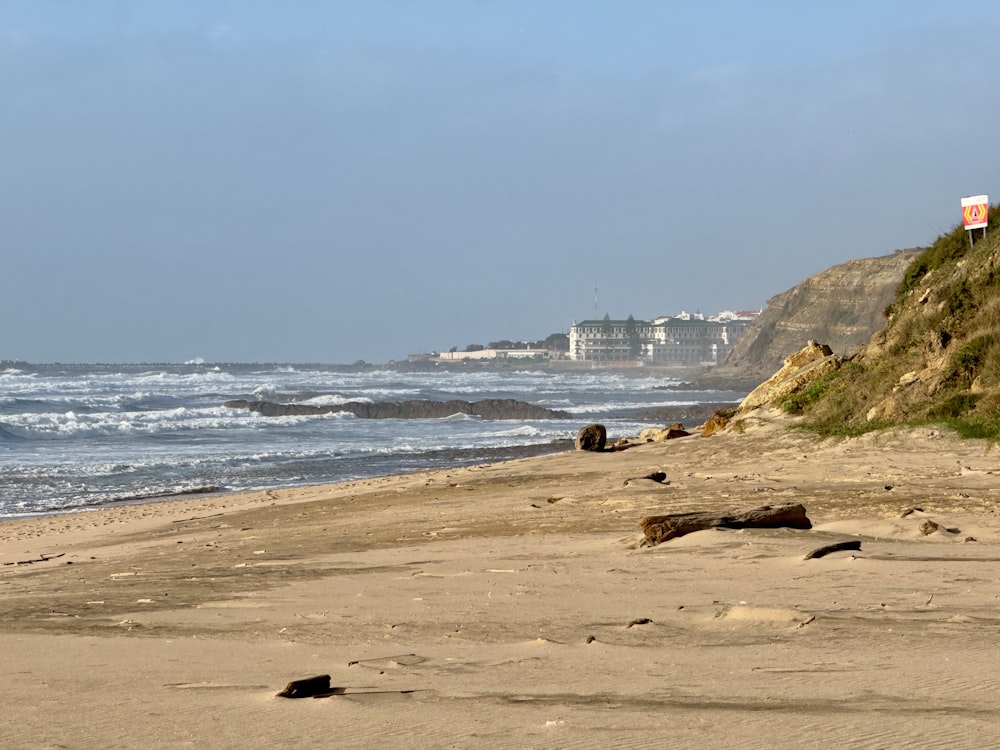 a sandy beach with waves coming in to shore