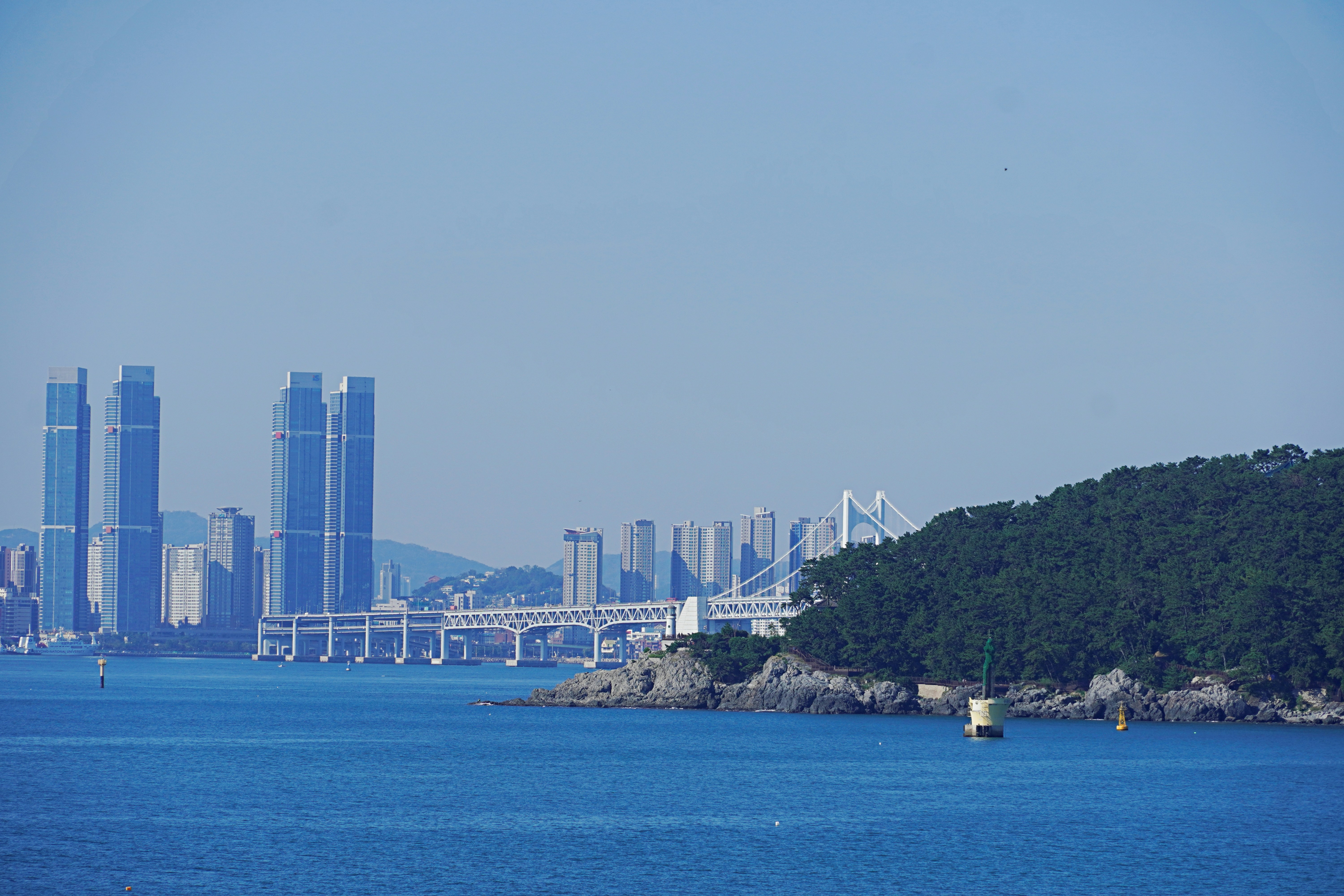 a large body of water with a city in the background