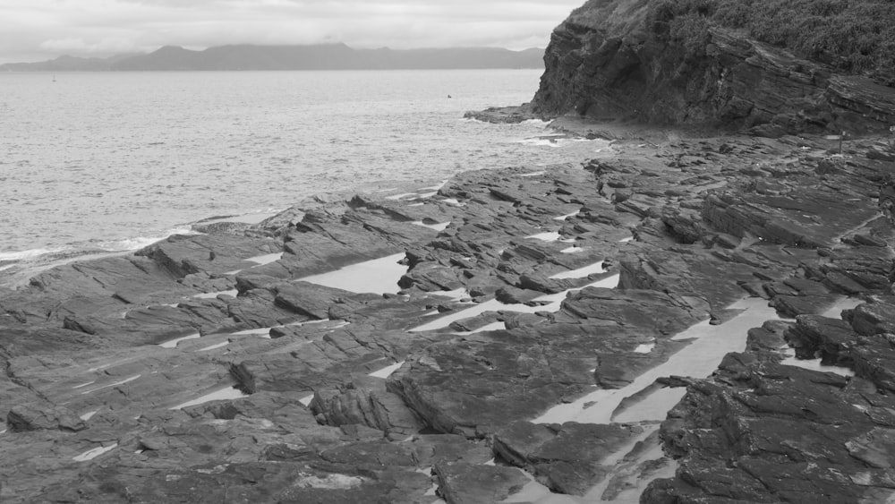 a black and white photo of a rocky beach