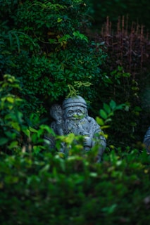 a statue in the middle of some bushes