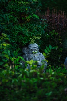 a statue in the middle of some bushes