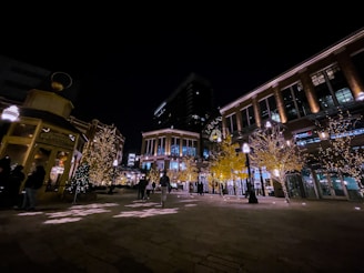 Night view of a festive Mexican plaza with traditional decorations and happy travelers
