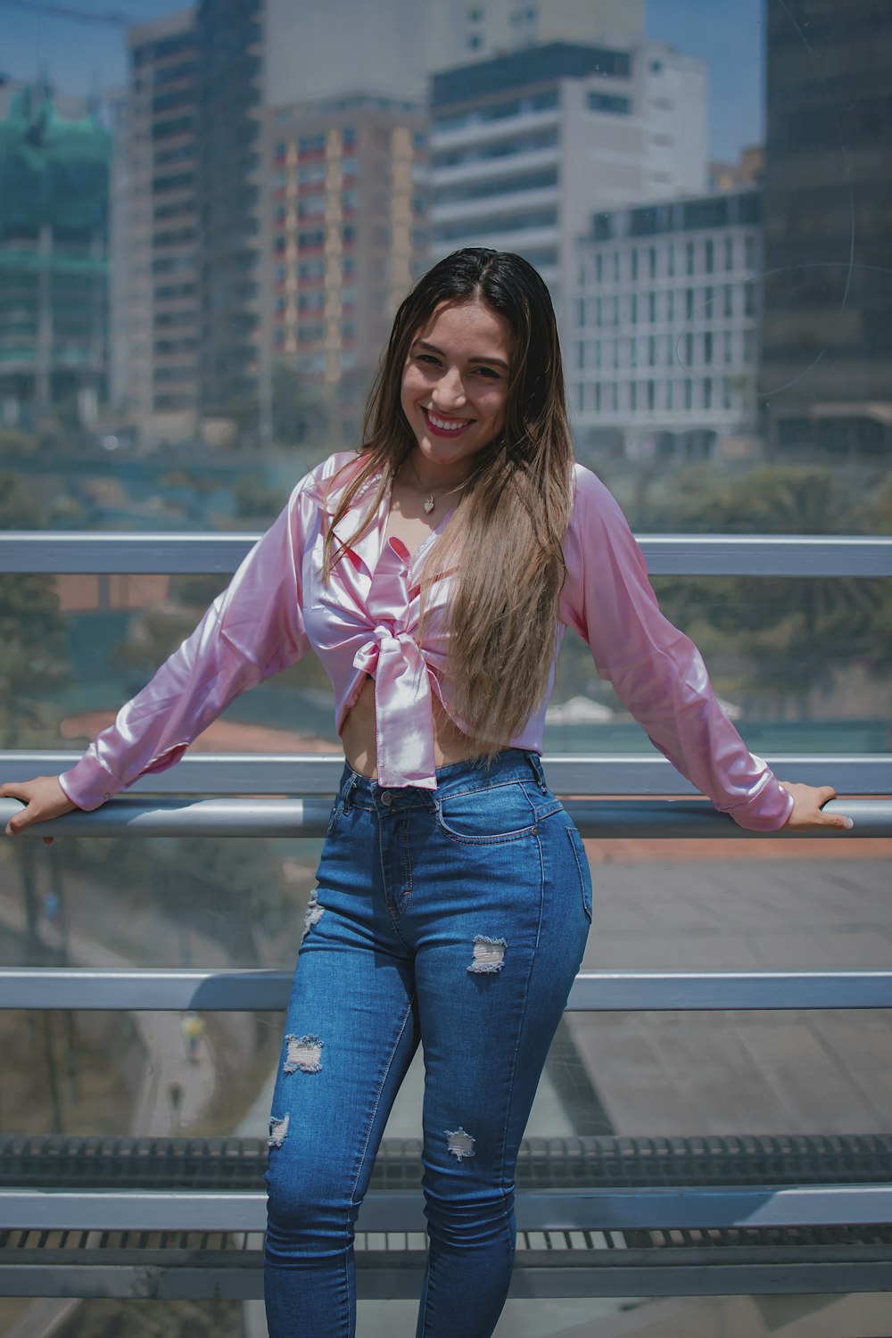 a woman with long hair standing on a balcony