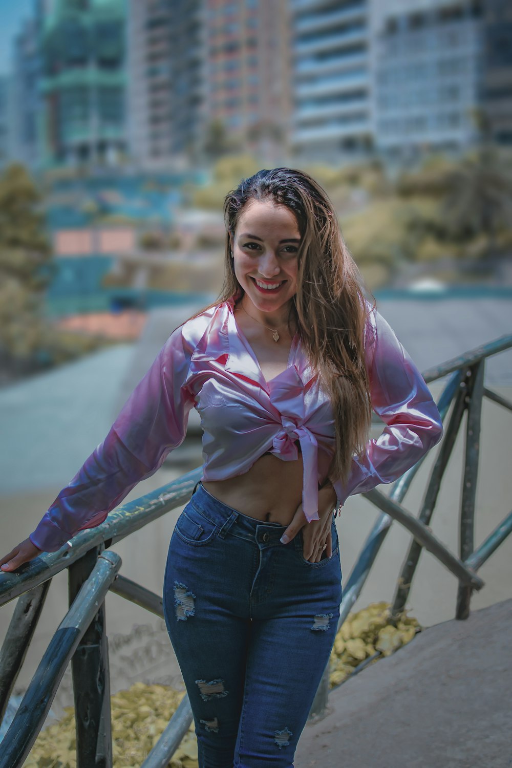 a woman standing on a bridge with her hands on her hips