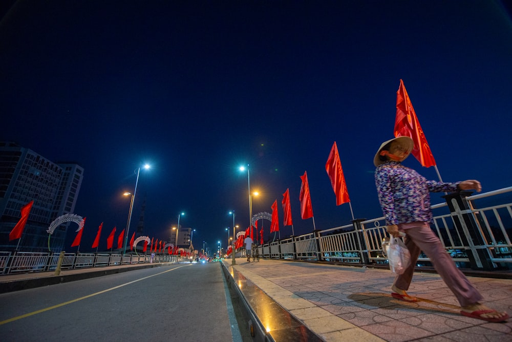 a man walking down a street at night