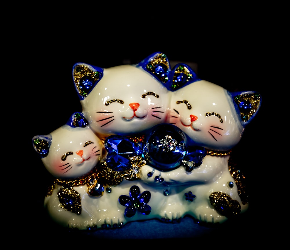 a group of three white cats sitting next to each other