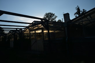Close-up of a sturdy polyhouse frame designed to resist strong winds, set against a bright blue sky.