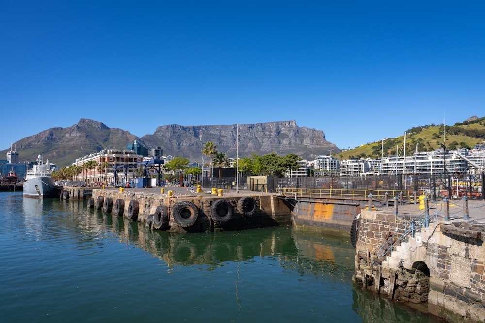 a large body of water with a mountain in the background