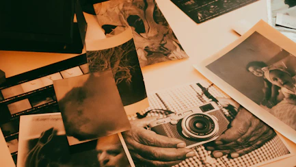 a table topped with pictures and a camera