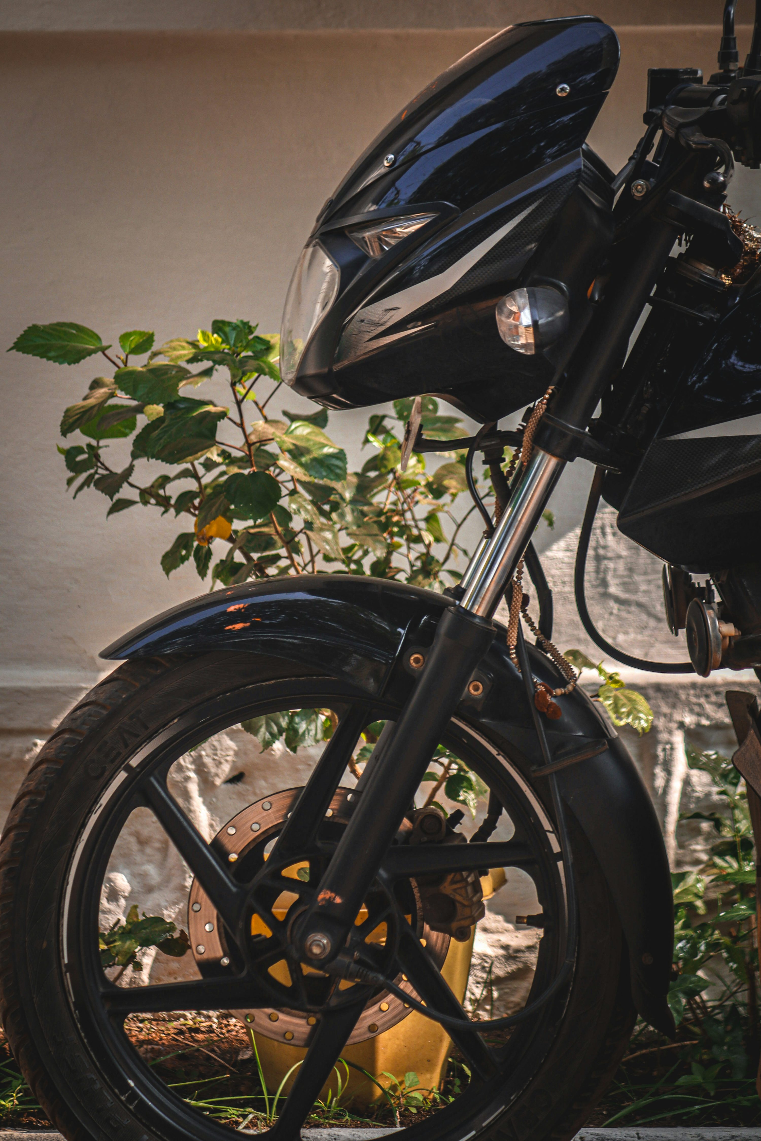 a black motorcycle parked in front of a building