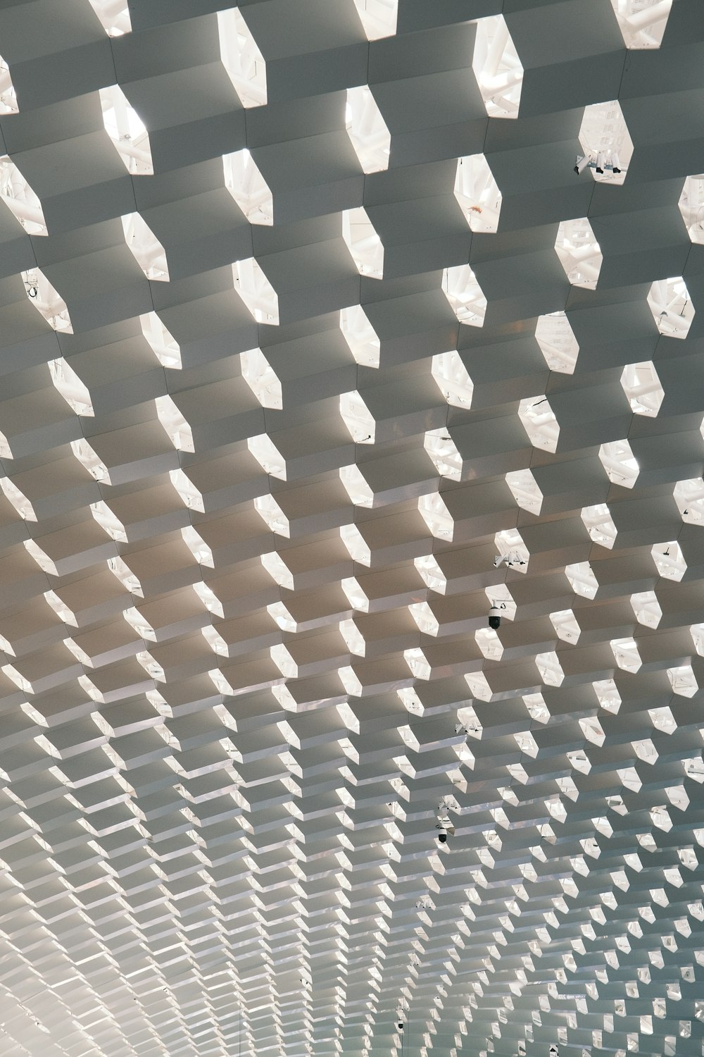 the ceiling of a train station is covered in white cubes
