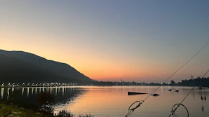 Sunset view over a calm lake with tourists relaxing after a day of adventure with Viajaviva