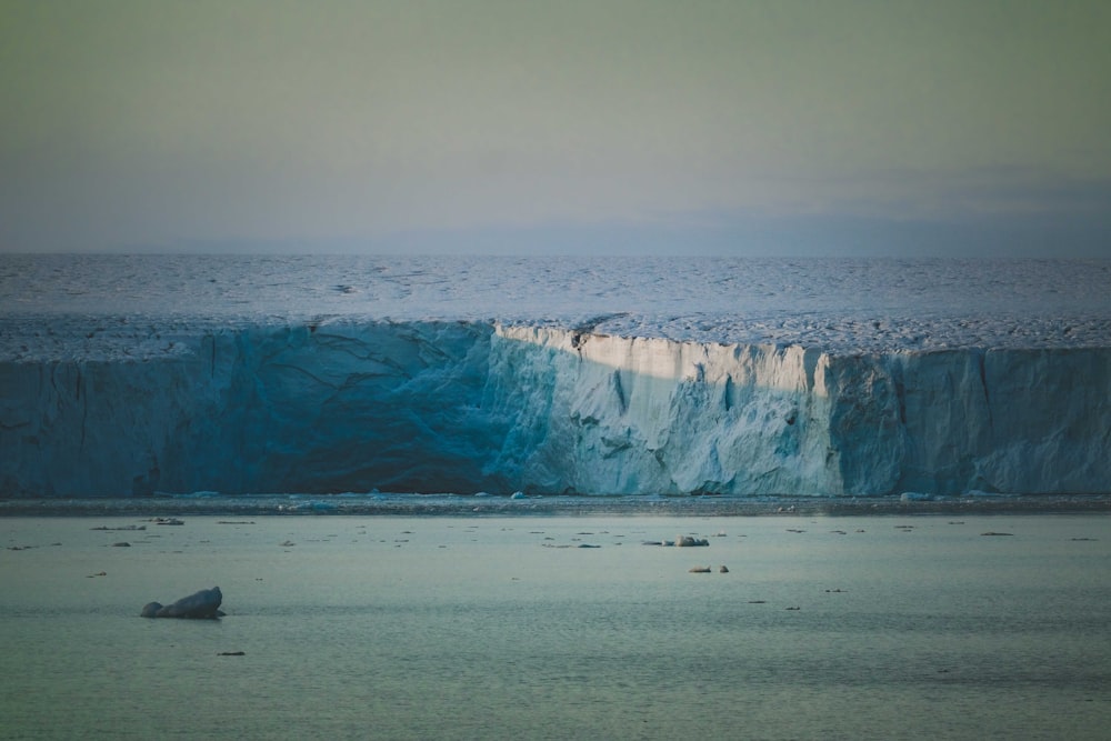 a large iceberg in the middle of a body of water