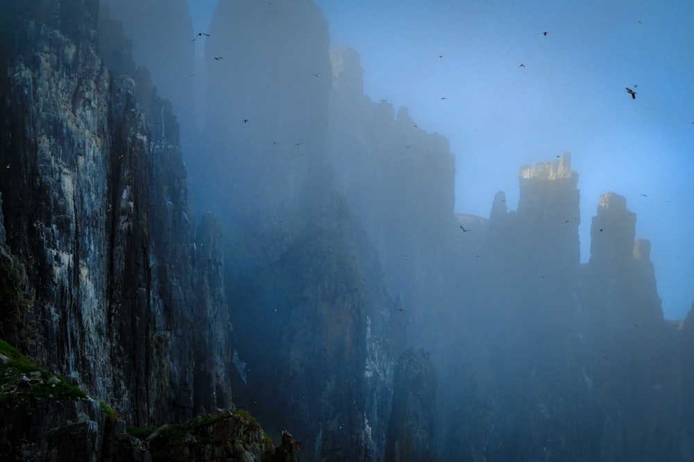 a foggy mountain with a castle in the distance