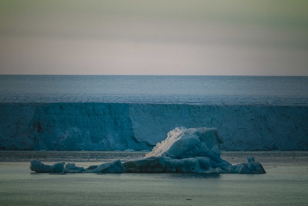 a large iceberg in the middle of the ocean