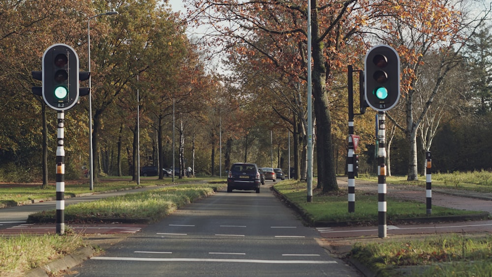 a green traffic light sitting on the side of a road