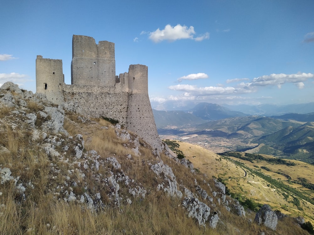 a castle on top of a hill with a sky background