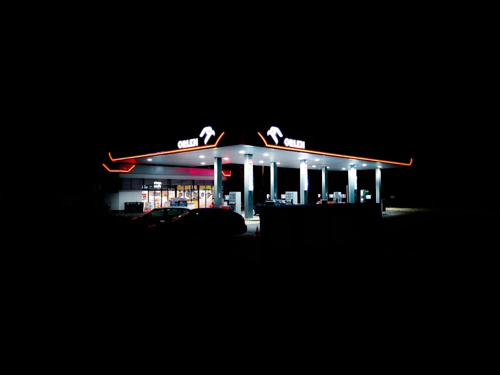 a gas station lit up at night in the dark