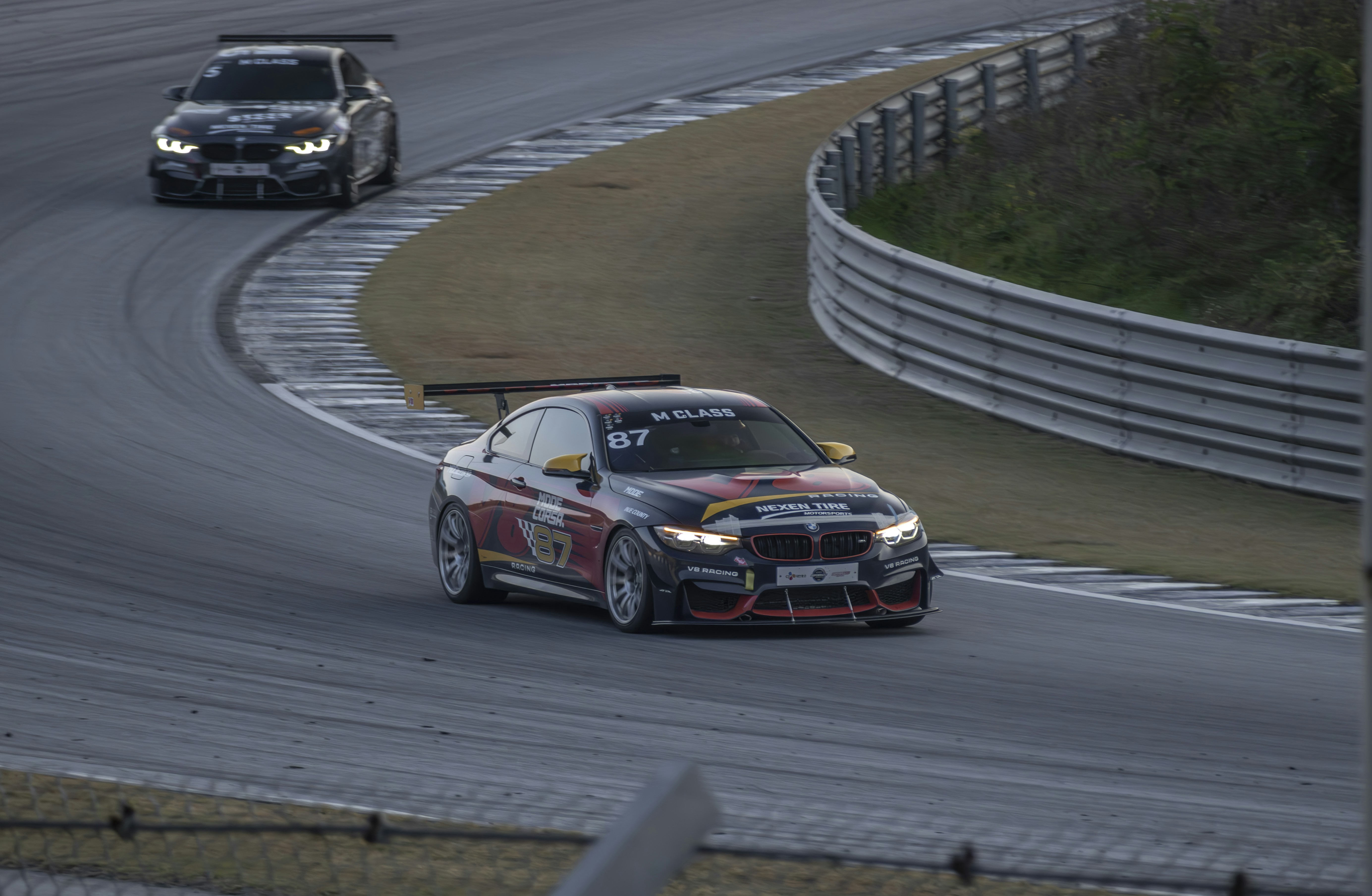 Two cars driving on a race track next to each other photo – Free Race ...