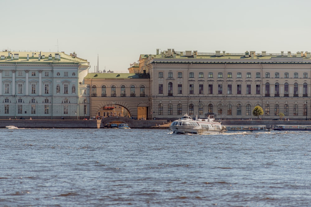 a boat in a body of water near a large building