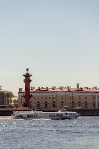 A sleek boat cruising along the Motlawa River at sunset with Gdansk’s historic skyline in the background.