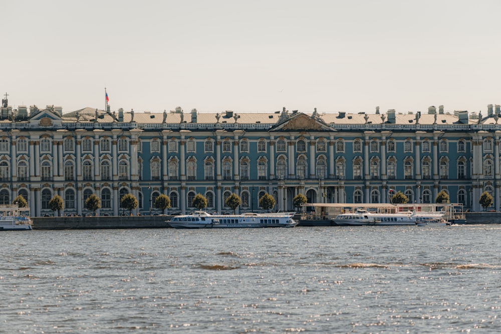 a large building sitting on the side of a river