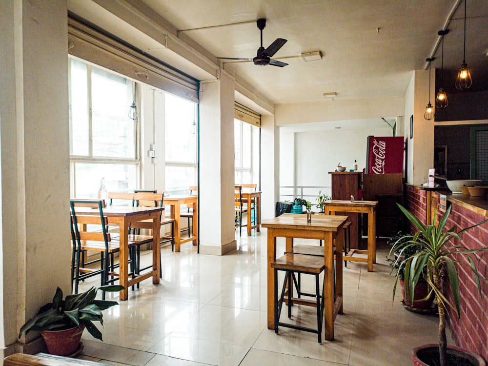 a restaurant with tables, chairs, and a flat screen tv