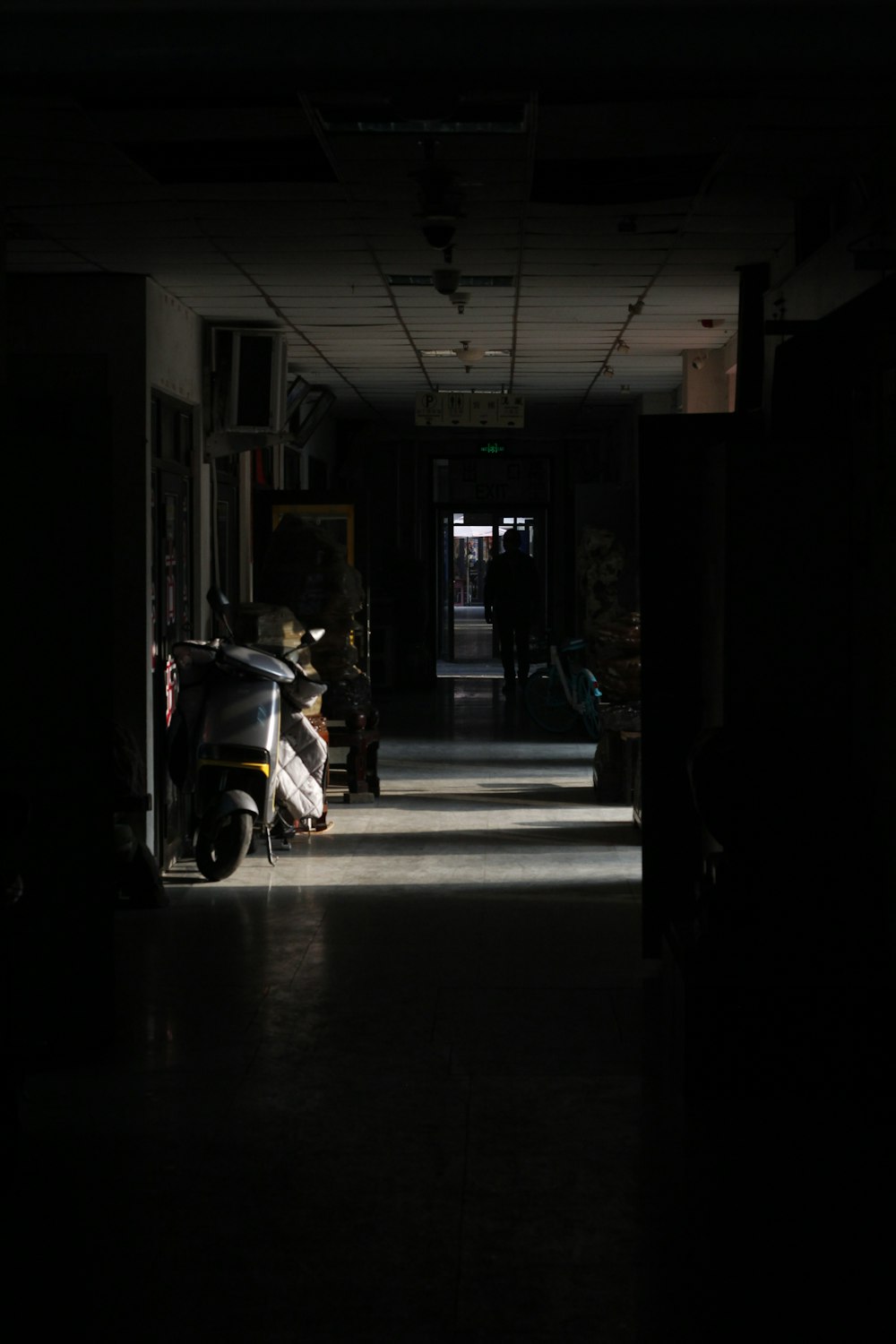 a scooter is parked in a dark hallway