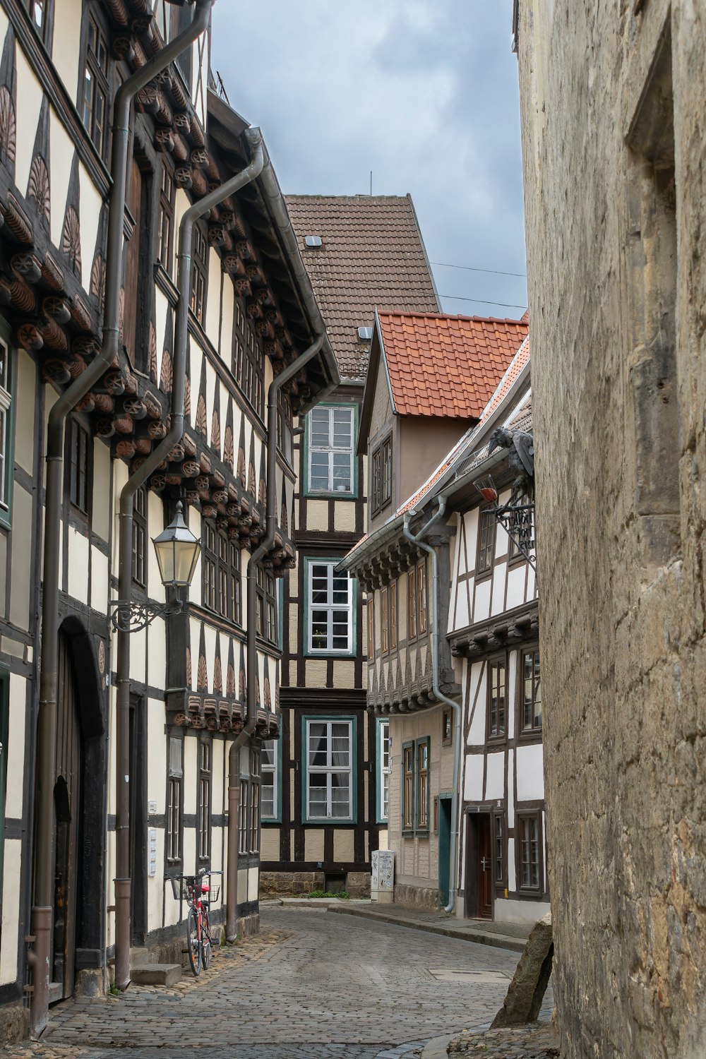 a cobblestone street lined with half - timber buildings