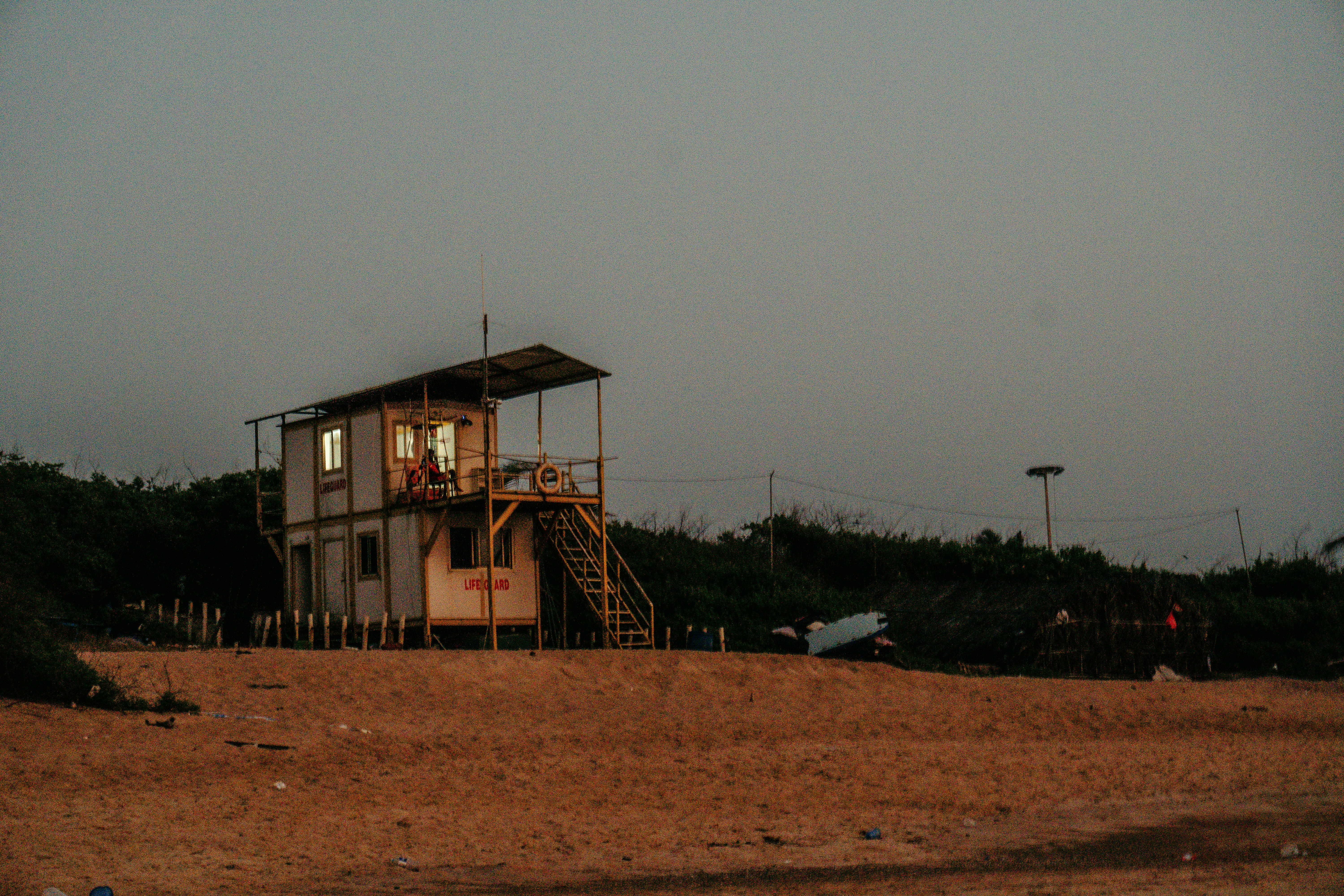 a lifeguard station on a beach with a life guard tower