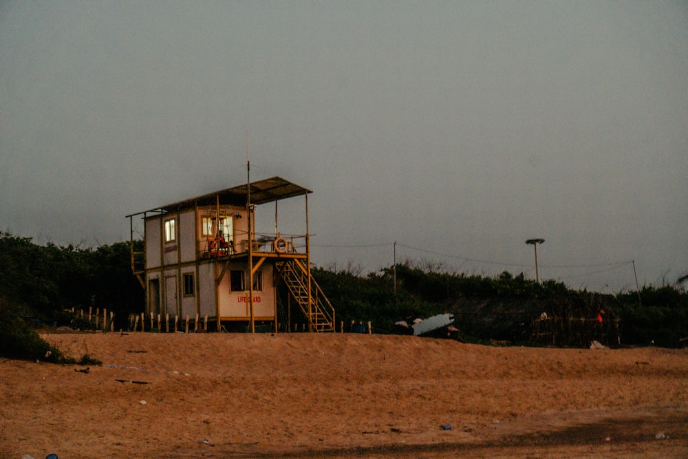 a lifeguard station on a beach with a life guard tower