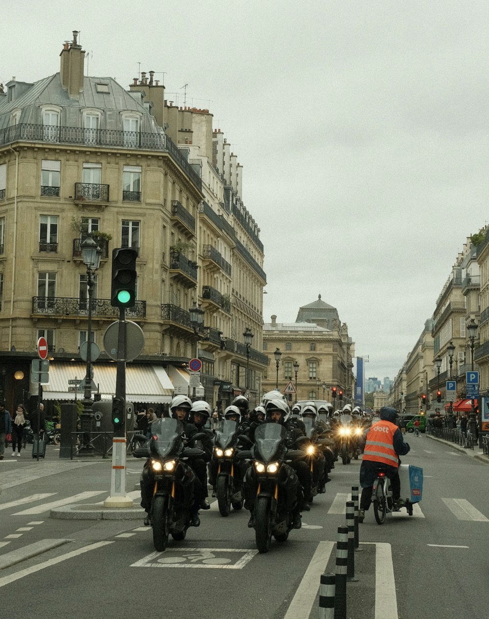 a group of people riding motorcycles down a street