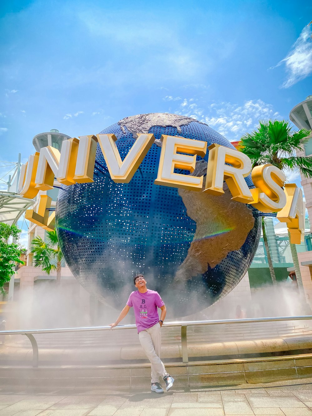 a man standing in front of a giant sign