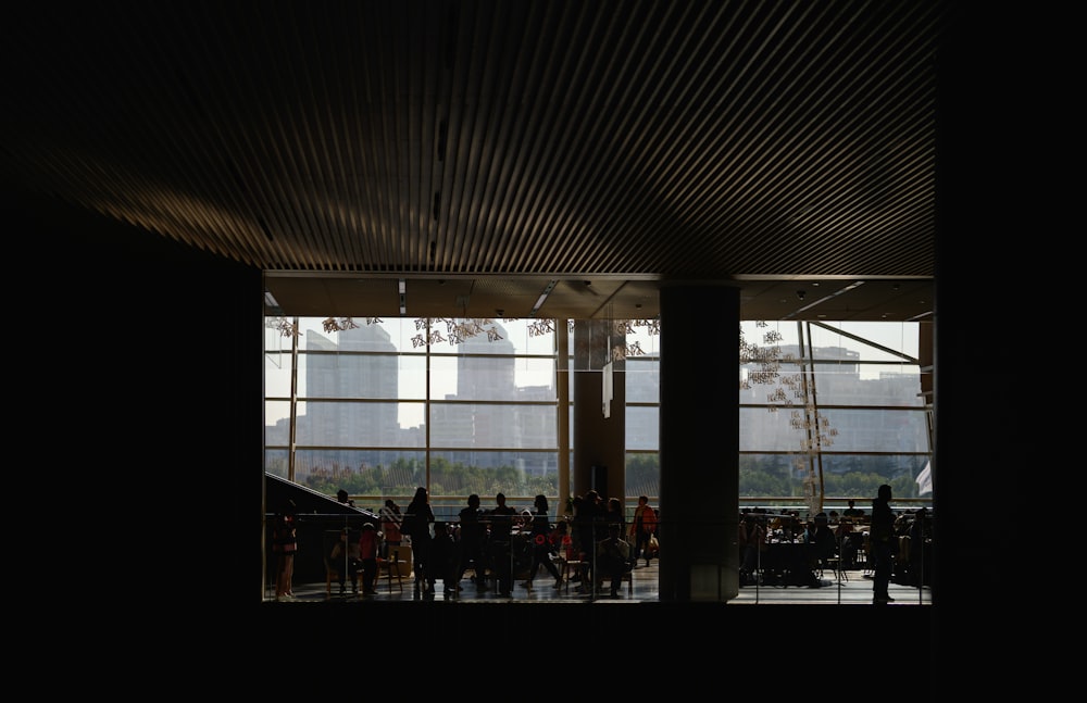 a group of people standing in front of a window