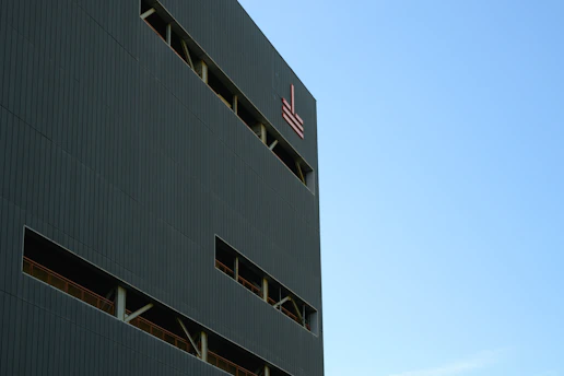 Elegant building exterior with a clear blue sky, symbolizing property management.