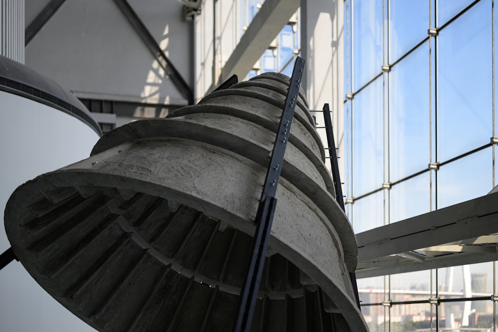 a large metal object in front of a building