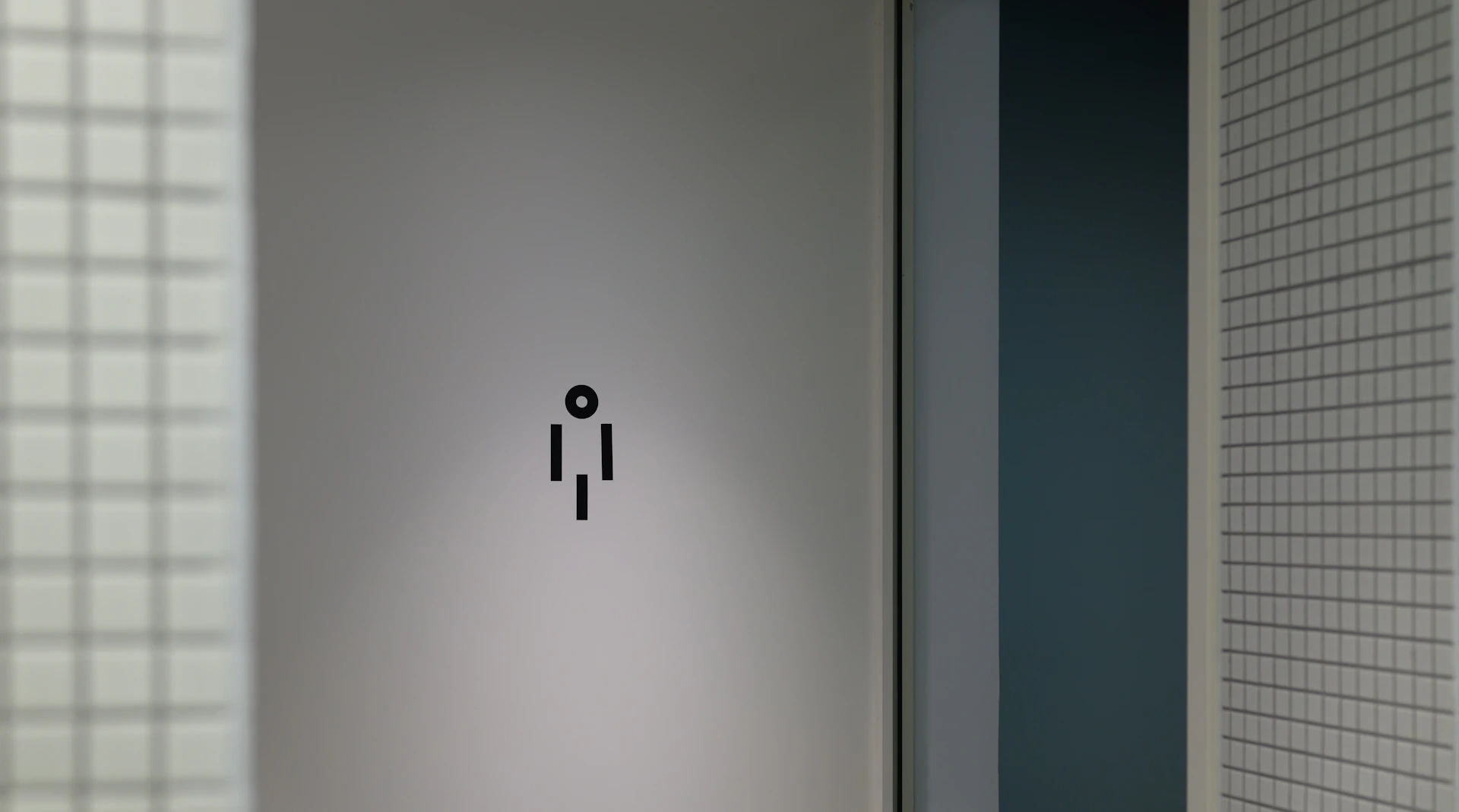 a bathroom door with a black and white sticker on it