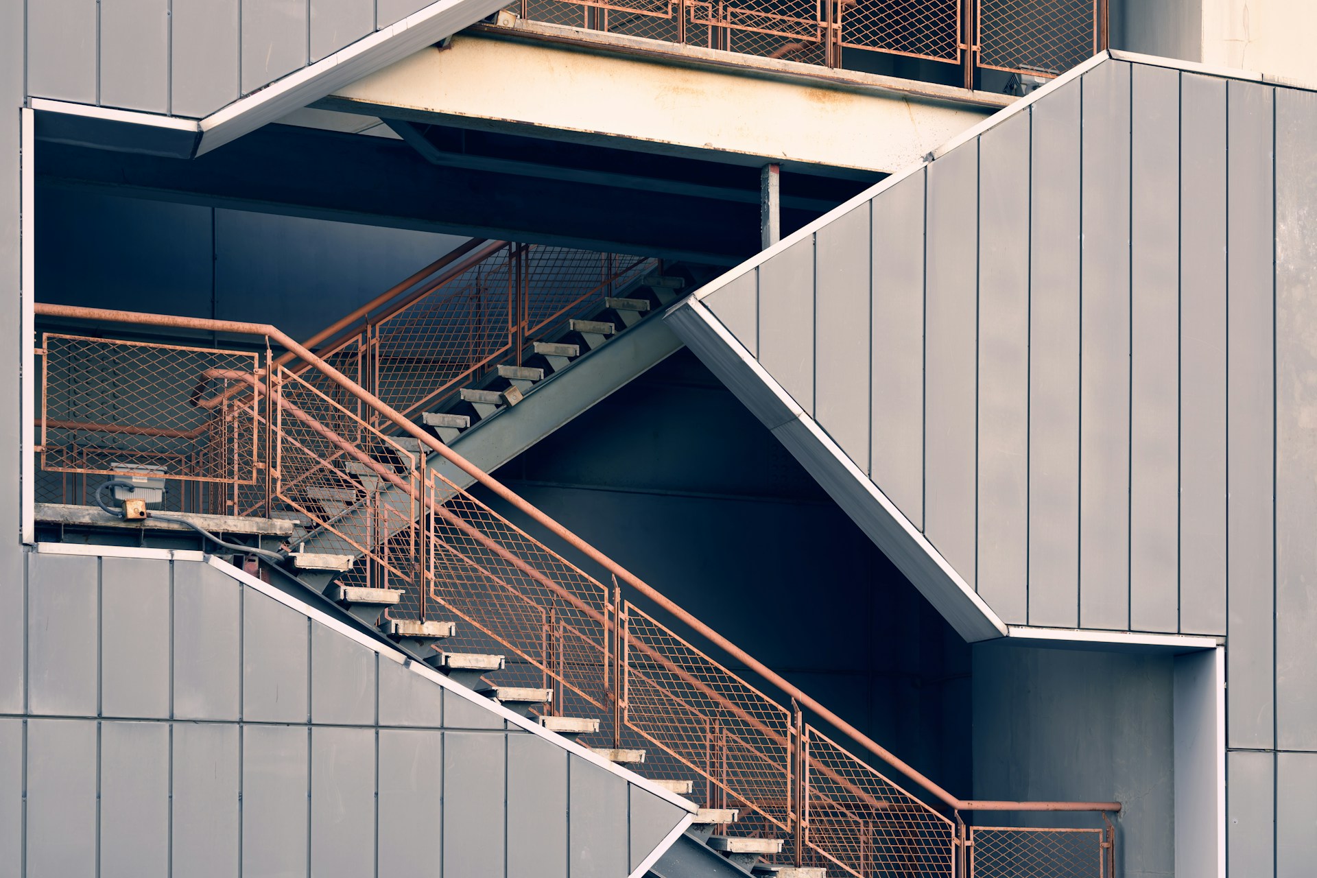 a metal stair case next to a building