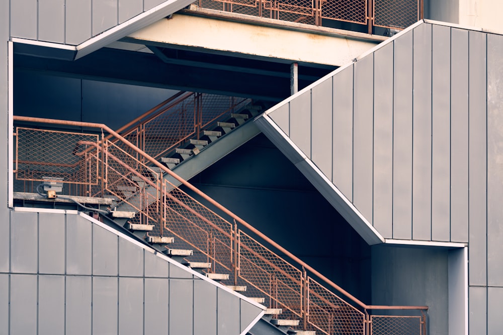 a metal stair case next to a building