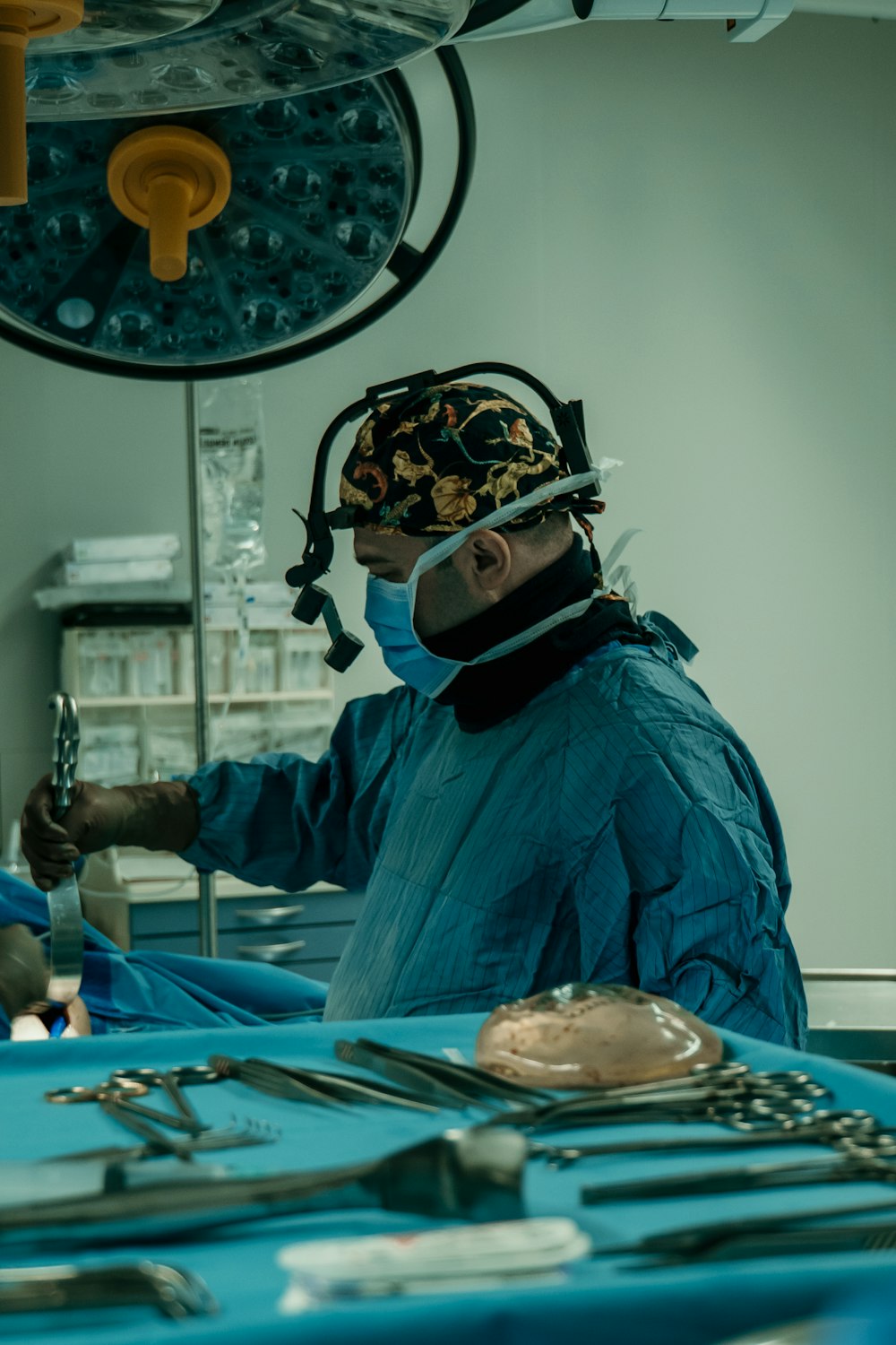 a man in a surgical gown is operating a machine