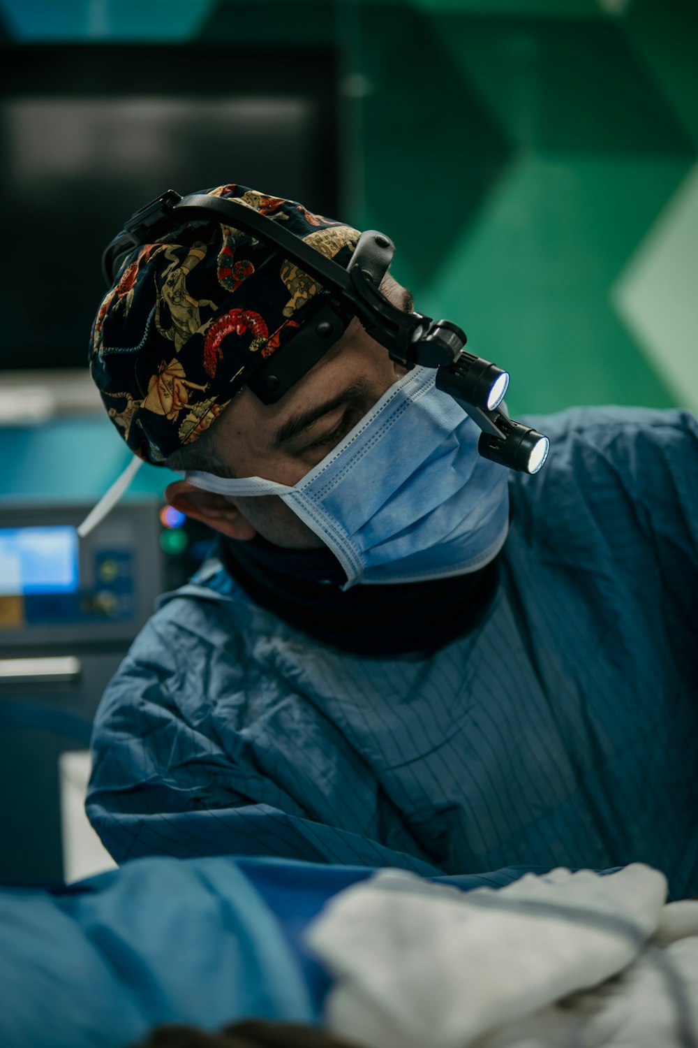 a man wearing a surgical mask while laying in a hospital bed