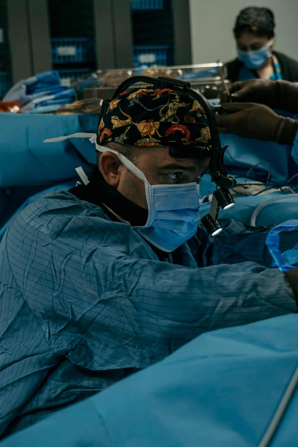 a man with a surgical mask on in a hospital