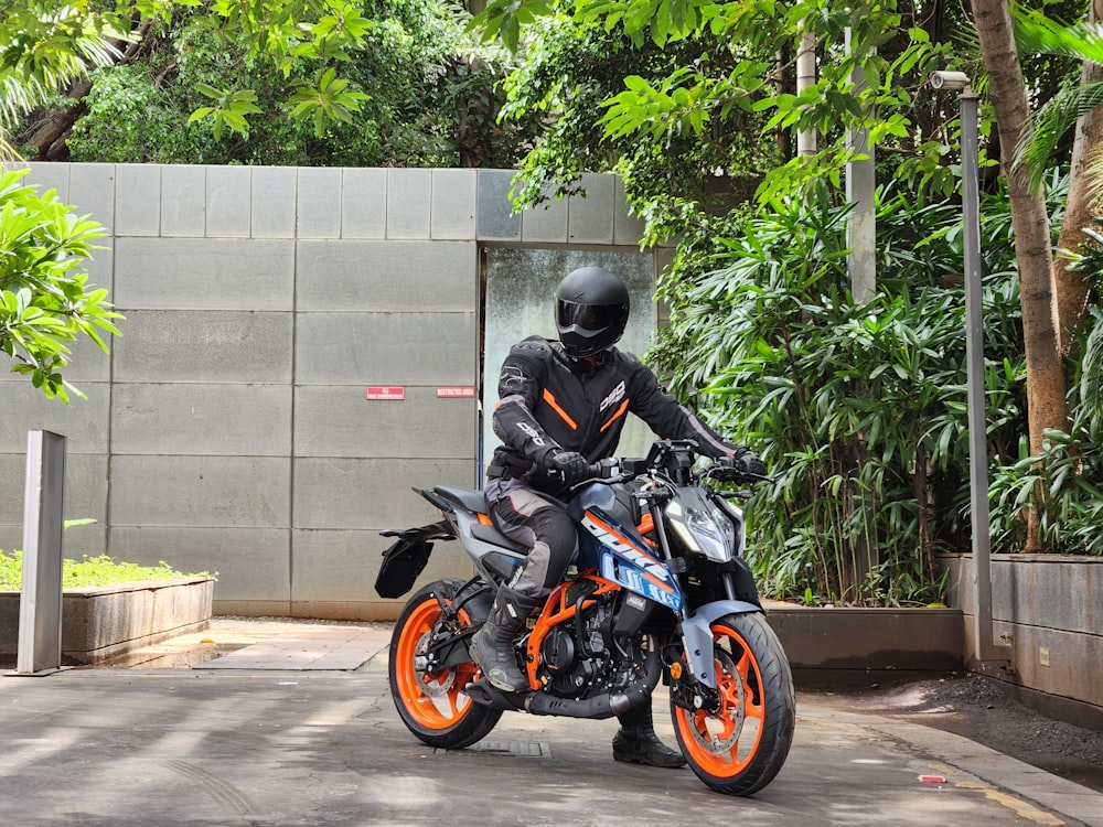 a man riding a motorcycle down a street