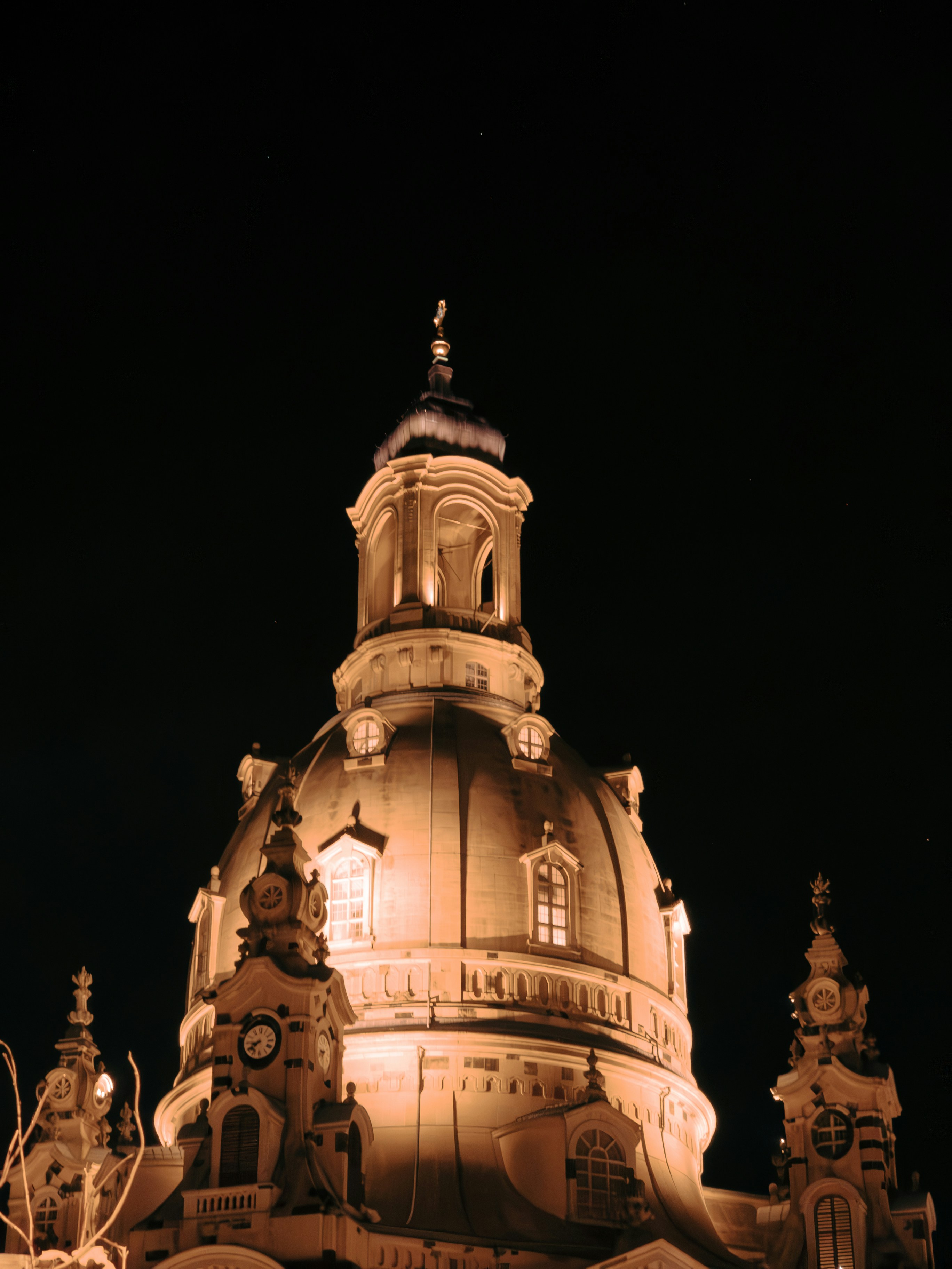 a large building with a clock tower at night