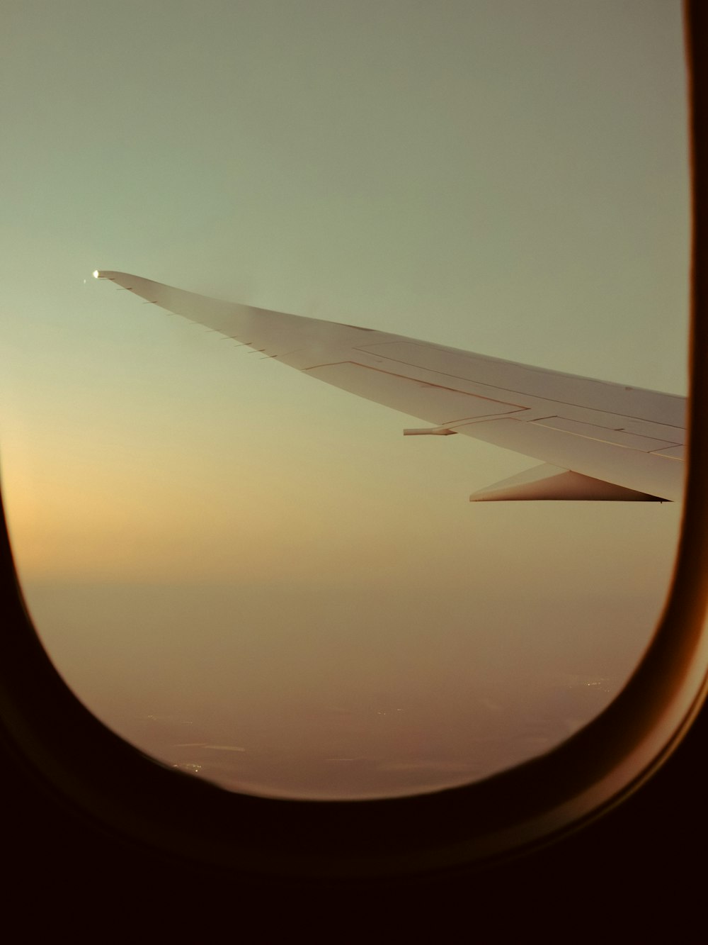 a view of the wing of an airplane in the sky